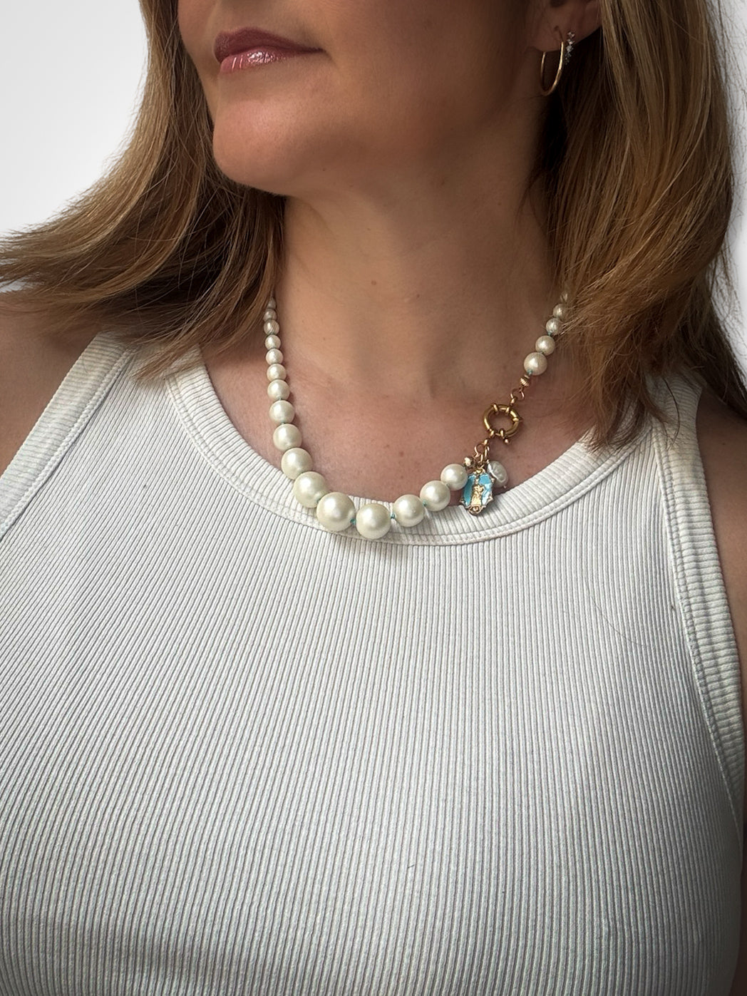 Fancy pearl necklace and turquoise silk thread.