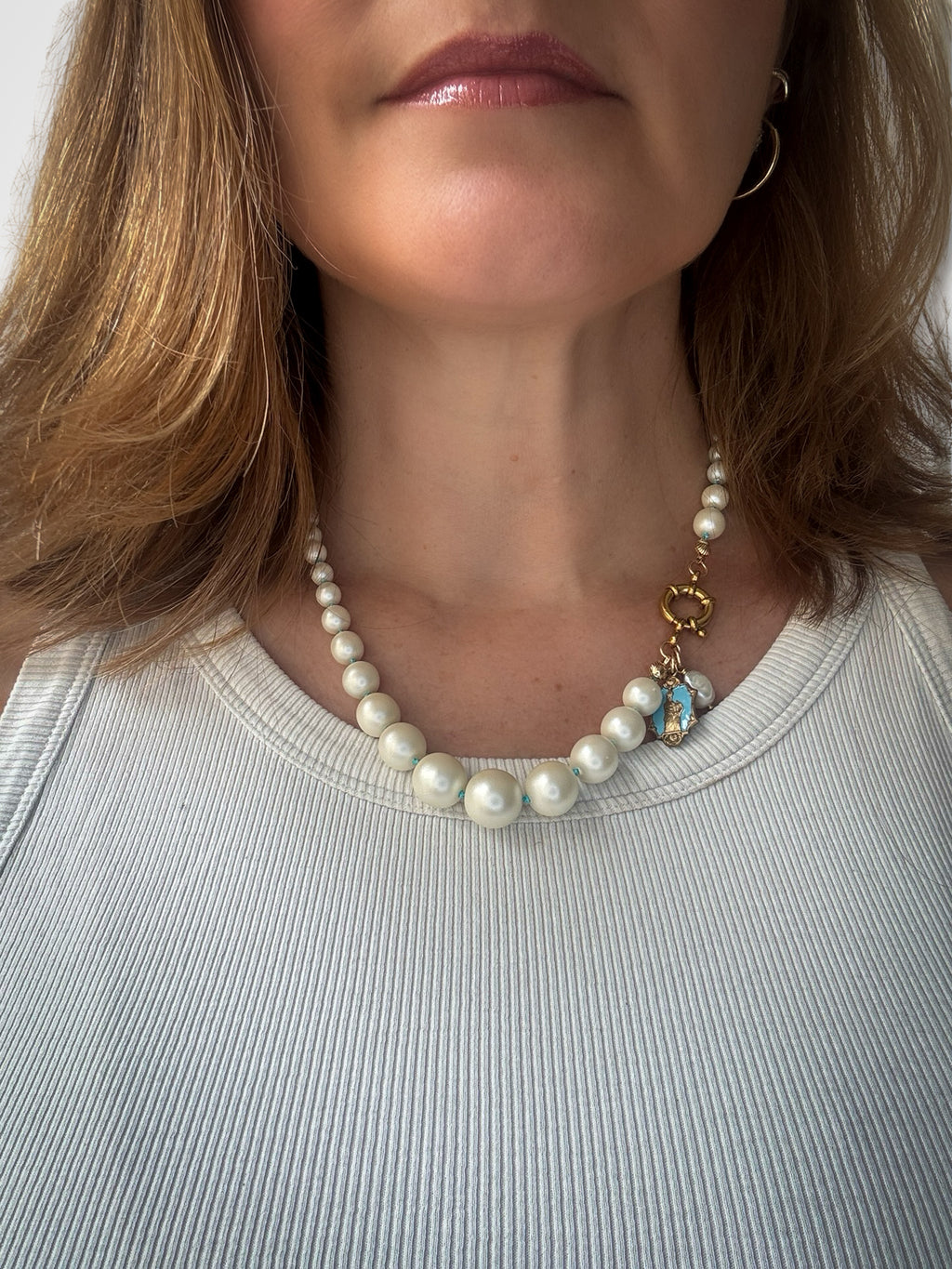 Fancy pearl necklace and turquoise silk thread.
